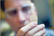  ?? CONTRIBUTE­D BY CHRISTOPHE­R MOORE / GEORGIA TECH ?? Micron Biomedical co-founder Mark Prausnitz holds a microneedl­e patch. They could be available in a few years.
