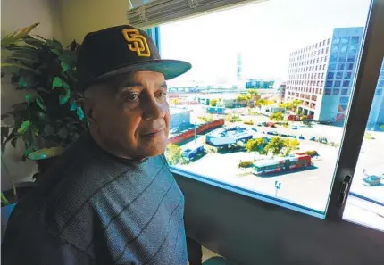  ?? NELVIN C. CEPEDA U-T ?? At Saint Teresa of Calcutta Villa on Feb. 28, Albert Zuniga, 61, relaxes in the apartment he has lived in since the downtown San Diego facility opened last year. Looking down from his window he says he see those who still live in tents — similar to how he once lived.