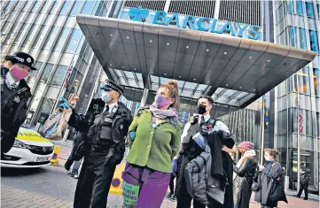  ??  ?? Police detain an Extinction Rebellion activist outside the Barclays offices in Canary Wharf, above. The Duke of Cambridge, below, urged banks to ‘invest in nature’