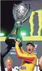  ??  ?? Joey Logano celebrates winning the Ford EcoBoost 400 and the NASCAR Cup Series championsh­ip on Sunday at Homestead-Miami Speedway. MARK J. REBILAS/USA TODAY
