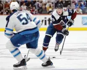  ?? Matthew Stockman/Getty Images ?? Nathan MacKinnon of the Colorado Avalanche advances the puck against the Winnipeg Jets in the second period at Ball Arena on April 13 in Denver.