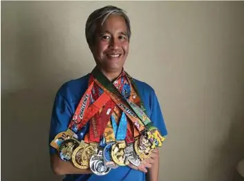 ?? Arin Sang-Urai/
Courtesy ?? Associated Press technology writer Nick Jesdanun poses with his medals, in Anaheim, Calif., following the Star Wars Half Marathon through Disneyland theme parks. The races were used to test Under Armour’s new gadgets and apps.