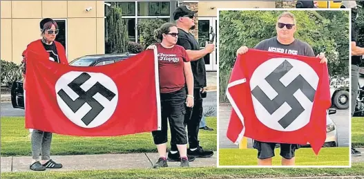  ?? ?? UNFURLING HATRED: A neo-Nazi group displays swastika flags outside a Georgia synagogue during its ugly weekend tour of hate.