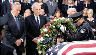  ?? Andrew Harnik/POOL Via REUTERS ?? Senator Chuck Schumer, left, and Mitch McConnell watche as a wreath is placed on the casket of Senator John McCain as he lies in state in the Rotunda of the US Capitol in Washington, yesterday. He will be buried today.