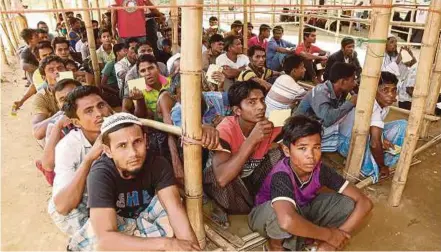  ?? EPA PIC ?? Rohingya refugees waiting for relief goods inside the UNHCR distributi­on point at the newly-extended camps in Cox’s Bazar earlier this week.