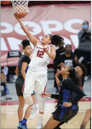  ?? (NWA Democrat-Gazette/Andy Shupe) ?? Arkansas guard Destiny Slocum (12) drives past Florida forward Jordyn Merritt for a layup during the first half of the Razorbacks’ victory Thursday night at Walton Arena in Fayettevil­le. Slocum finished with 17 points and teammate Chelsea Dungee had 33. More photos available at arkansason­line.com/115uafla.