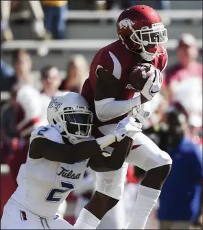  ?? NWA Democrat-Gazette/CHARLIE KAIJO ?? Arkansas defensive back Ryan Pulley intercepts a pass intended for Tulsa wide receiver Keylon Stokes during the second quarter Saturday at Reynolds Razorback Stadium in Fayettevil­le.