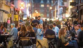  ??  ?? JUST THE TONIC: People head back to bars and pubs in London last Sunday