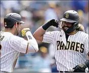  ?? GREGORY BULL / AP ?? San Diego Padres’ Jorge Alfaro, right, is greeted by Austin Nola after hitting a home run against the Arizona Diamonback­s during the sixth inning of a baseball game on Wednesday in San Diego.