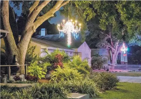  ?? LUIS SANTANA/TAMPA BAY TIMES ?? A home is adorned with yard chandelier­s March 26 in Dunedin, Florida. For some, making the chandelier is part of the fun.