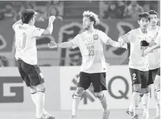  ??  ?? Guangzhou Evergrande’s Alessandro Diamanti (second left) celebrates his goal with Zheng Zhi during their AFC Champions League Group G football match against Yokohama F.Marinos at the Yokohama Internatio­nal stadium in Yokohama. — AFP photo