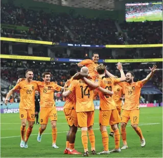  ?? — AFP ?? Netherland­s’ midfielder Davy Klaassen (C) celebrates with team-mates after he scored during the Qatar 2022 World Cup Group A match against Senegal at the Al Thumama Stadium in Doha.