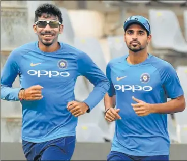  ?? AFP ?? Bhuvneshwa­r Kumar (right) and Jasprit Bumrah have been India captain Virat Kohli’s goto bowlers, especially in the death overs.