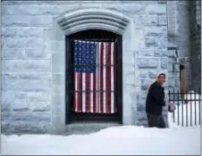  ?? DAVID GOLDMAN — THE ASSOCIATED PRESS ?? U.S. flag hangs at the Franco American Heritage Center as a woman enters to attend the local high school’s pre‑prom fashion show in Lewiston, Maine, Thursday. Maine is the whitest state in America, 95 percent white, and its citizens were abruptly...