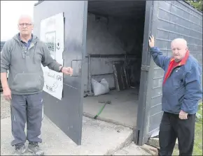  ??  ?? Mick Wall, left, secretary Kanturk Soccer Club and John O’Neill, committee; beside the shed where valuable club equipment including a ride-on lawnmower were stolen.