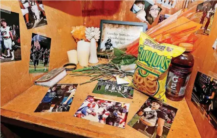  ?? [PHOTOS BY NATE BILLINGS, THE OKLAHOMAN] ?? Photos and other items in Kayson Toliver’s locker, after Monday’s football practice for the Beggs Golden Demons. The 18-year-old Beggs senior running back was shot and killed on Nov. 1.