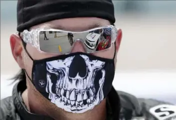  ?? Associated Press ?? FASHION STATEMENT Even NASCAR drivers are turning their masks into fashion statements. Driver BJ McLeod waits for the start of an Xfinity race Saturday in Homestead, Fla.