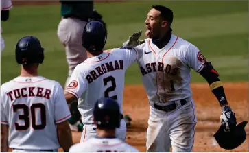  ?? AP PHOTO BY ASHLEY LANDIS ?? Houston Astros’ Carlos Correa, right, celebrates after hitting a three-run home run that scored Kyle Tucker (30) and Alex Bregman (2) during the fourth inning of Game 4 of a baseball American League Division Series against the Oakland Athletics in Los Angeles, Thursday, Oct. 8.