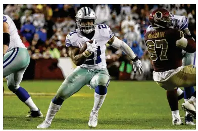  ?? ROB CARR / GETTY IMAGES ?? Cowboys running back Ezekiel Elliott (center) runs upfield during the fourth quarter against the Washington Redskins. Elliott ran for 150 yards on 33 and scored two touchdowns in Dallas’ 33-19 victory.