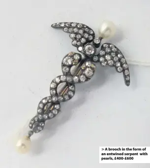  ??  ?? > A brooch in the form of an entwined serpent with pearls, £400-£600