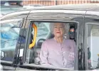  ??  ?? A person impersonat­ing Britain’s Queen Elizabeth is driven past the Lindo Wing after Catherine, the Duchess of Cambridge, gave birth to a son.