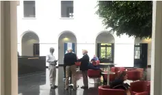  ??  ?? Servansing, Graham and Bhatia confer in the WTO’s atrium in Geneva, Switzerlan­d. — Reuters photo