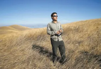  ??  ?? Juan Pablo Galvan Martinez, senior land use manager with Save Mount Diablo, views the site of the proposed residentia­l developmen­t in the hills southwest of Pittsburg.