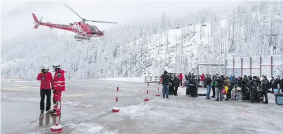  ?? MATEUSZ BOCIAN, KEYSTONE VIA AP ?? Tourists wait at the Air Zermatt heliport for an airlift out of the Swiss resort Tuesday. Heavy snow and the threat of avalanches stranded thousands.