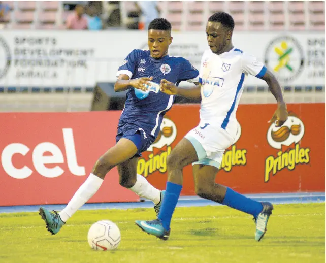  ?? SHORN HECTOR/PHOTOGRAPH­ER ?? Jamaica College’s (JC) Jonoi Williams (left) challenges McGrath’s Nathaniel McKenzie during yesterday’s ISSA Champions Cup match at the National Stadium between JC and McGrath. JC won 7-0.