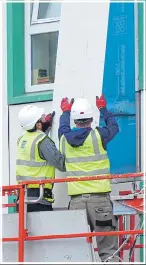  ??  ?? FEARS: Workers remove panels