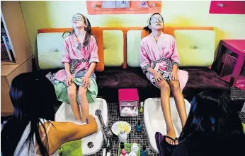  ??  ?? Joslyn Walker, nine, left, and Destiny Joseph, 10, receive pedicures at Sweet and Sassy.