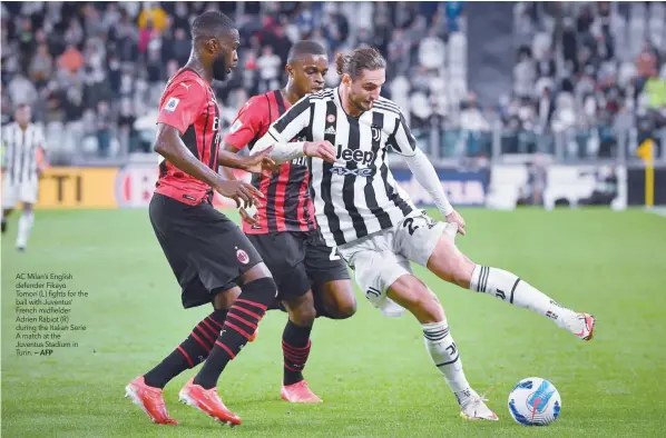  ?? — AFP ?? AC Milan’s English defender Fikayo Tomori (L) fights for the ball with Juventus’ French midfielder Adrien Rabiot (R) during the Italian Serie A match at the Juventus Stadium in Turin.