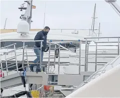  ?? REUTERS ?? An official climbs on board a seized superyacht owned by Russian oligarch Viktor Vekselberg in Mallorca, Spain last month.