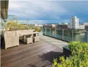  ??  ?? Clockwise from above: the upstairs living room opens out onto a terrace; the Hanover Quay developmen­t; a bedroom with balcony; the view from the apartment looking over the quays and the Aviva Stadium and, left, the terrace