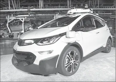  ?? Detroit News/JOSE JUAREZ ?? In this June photo, a self-driving Chevrolet Bolt EV that is in General Motors Co.’s autonomous vehicle developmen­t program appears on display at GM’s Orion Assembly in Lake Orion, Mich.