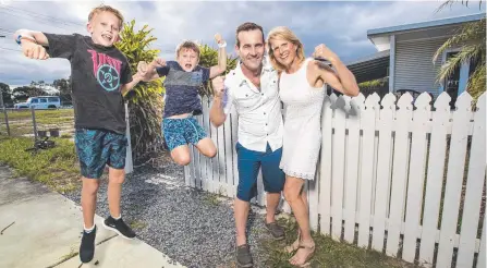  ?? Picture: NIGEL HALLETT ?? Edwina and Shaun Roberts with their sons Finn, 11, and Ryan, 9, celebrate outside their Mermaid Beach shack.