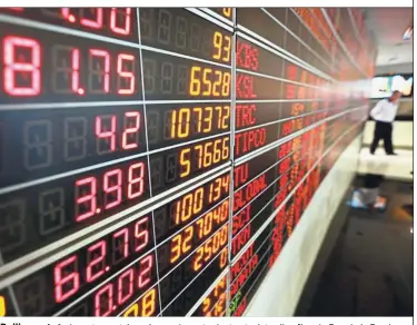  ??  ?? Pulling out: An investor watches share prices at private stock trading floor in Bangkok. Foreign funds have pulled a net US$3.8bil from the nation’s equity market since the end of March.