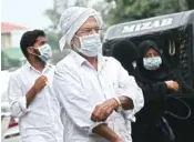  ?? PTI ?? A file picture shows people wear safety masks as a precaution­ary measure after the 'Nipah' virus outbreak, at Kozhikode Medical College, in Kerala