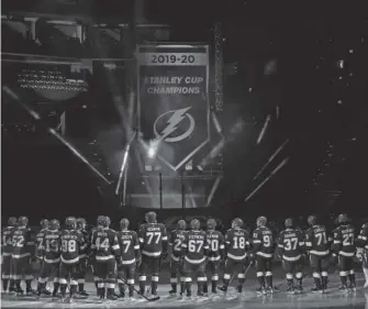  ?? AP ?? Lightning players look on as their 2019-2020 Stanley Cup Champions banner is revealed on Wednesday in Tampa, Fla.