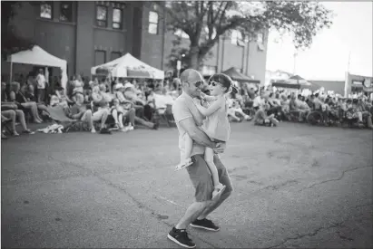  ?? @TMartinHer­ald Herald photo by Tijana Martin ?? David Logue dances with his daughter Juliette, 4, during the free outdoor Wide Skies Music and Arts Festival on Wednesday night.