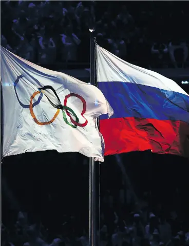  ?? CLIVE MASON / GETTY IMAGES FILES ?? The Olympic and Russian flags at Sochi in 2014. Removing Russia from Pyeongchan­g makes the South Korean Winter Games much smaller, Scott Stinson writes.