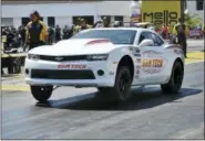  ?? THE ASSOCIATED PRESS ?? Drag racer Leah Pritchett pulls a wheelie during a practice run for the Papa John’s Charity Challenge at the NHRA Gatornatio­nals Saturday in Gainesvill­e, Fla. Pritchett is pulling triple-duty at Gainesvill­e Raceway by competing in her normal Top Fuel...