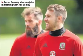  ??  ?? > Aaron Ramsey shares a joke in training with Joe Ledley