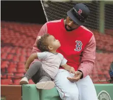  ?? STAFF PHOTO BY NANCY LANE ?? JUST KIDDING AROUND: Jackie Bradley Jr. hangs out with his 2-year-old daughter, Emerson, during the Red Sox’ workout yesterday at Fenway Park.