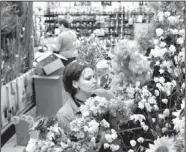  ?? Staff photo by John Rawlston ?? Lisa Carroll places dried flowers out for display Thursday as workers prepare for the opening of the new Michael's store at Northgate.