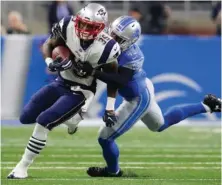 ?? AP PHOTO ?? BACK IN ACTION: Mike Gillislee is tackled by the Lions’ Charles Washington during the Patriots’ 30-28 victory last night in Detroit.