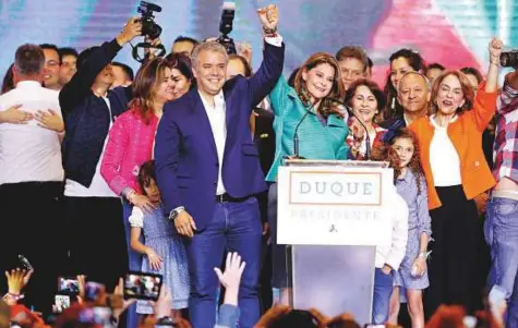  ?? Reuters ?? Presidenti­al candidate Ivan Duque and his candidate for Vice-President Marta Lucia Ramirez celebrate after Duque won the presidenti­al election in Bogota, Colombia, on Sunday.