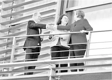  ??  ?? Nahles (second right), Federal finance minister (SPD) Olaf Scholz (left) and Merkel stand on a balcony as they take part in a coalition committee at the Chanceller­y in Berlin. — AFP photo