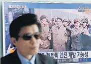  ?? [AP PHOTO] ?? A TV news program playing at Seoul Railway Station in Seoul, South Korea, shows an image of North Korean leader Kim Jong Un at the country’s Sohae launch site. The letters read “New type engine.”