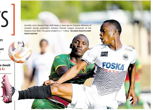  ?? RICARDO MAKYN/CHIEF PHOTO EDITOR ?? Humble Lion’s Xavian Virgo (left) keeps a close eye on Dwayne Atkinson of Cavalier during yesterday’s Jamaica Premier League encounter at the Stadium East field. The game ended in a 1-1 draw.